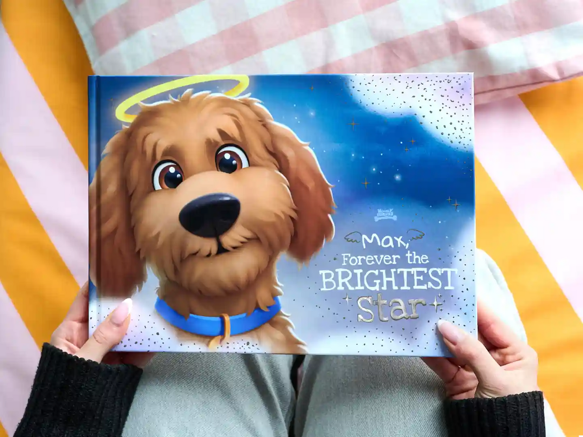 Premium personalized dog memorial book titled "Max, Forever the Brightest Star" with foil text on the cover, honoring a beloved pet with heartfelt stories.
