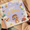 Woman holding a personalized book for newborn baby.