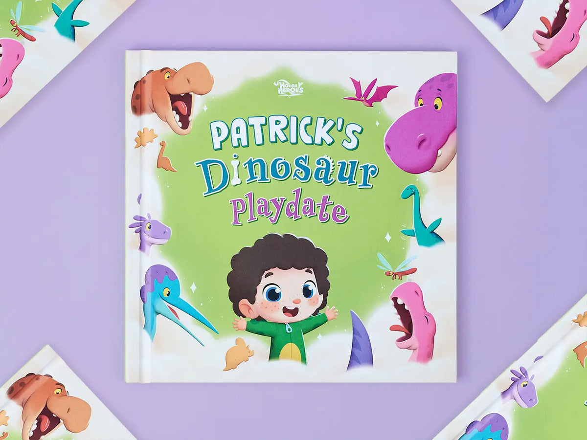 Boy holding Hooray Heroes' bestselling dinosaur book were you can customize the look of your kid.