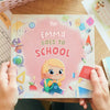 Girl holding a personalized for going back to school by Hooray Heroes.