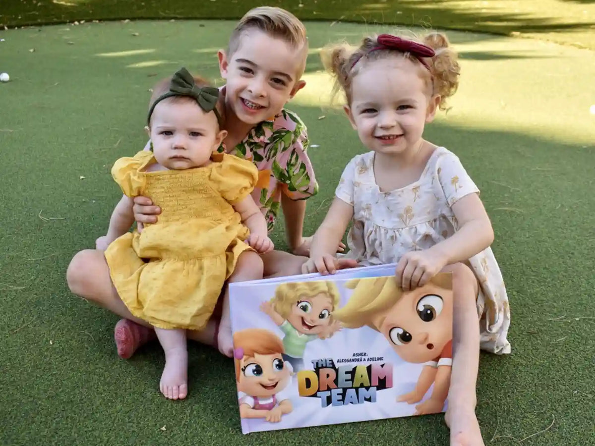 A little trio of brothers and sisters gathered thanks to their personalized story book from Hooray Heroes.