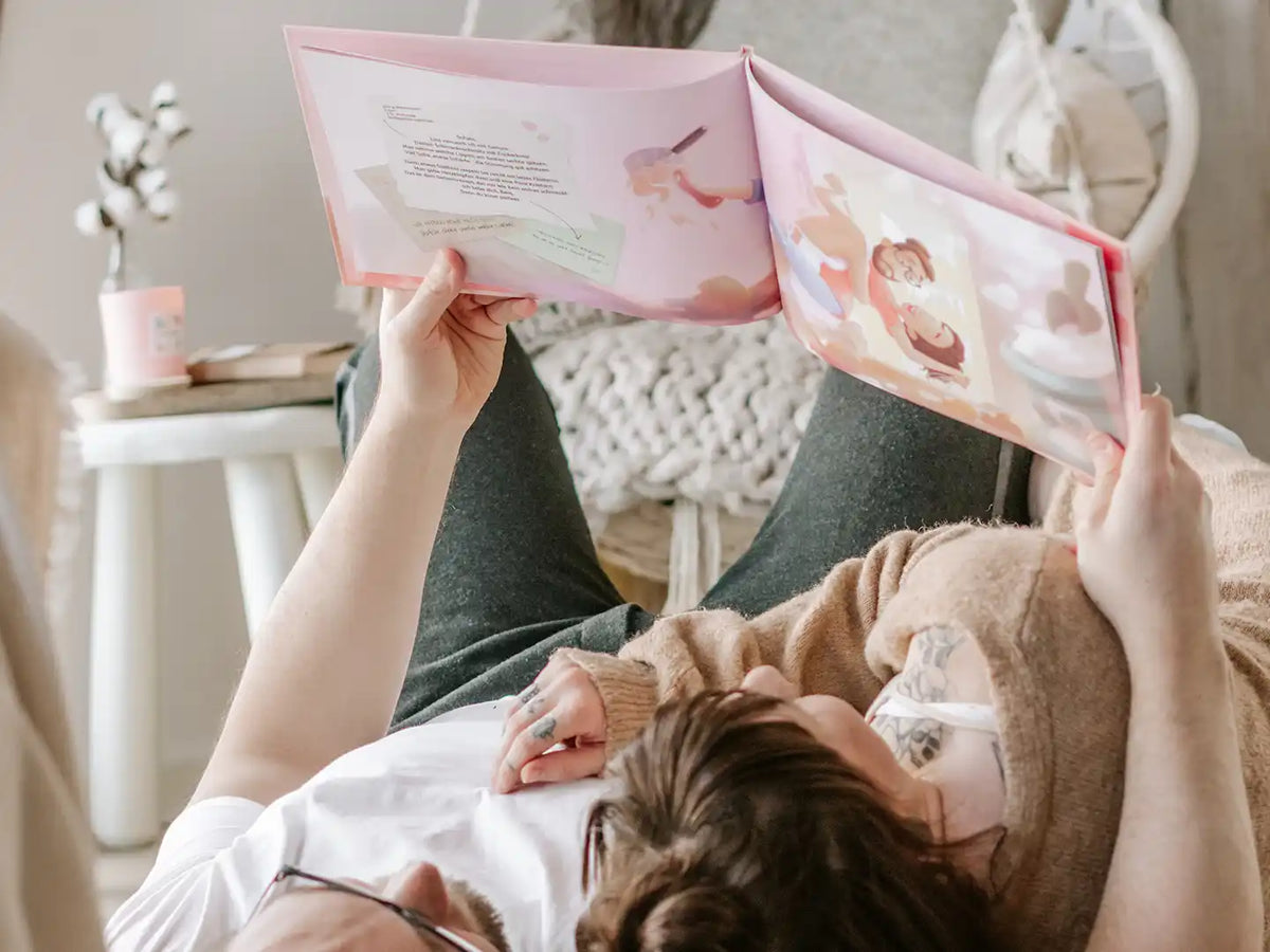 Girlfriend and boyfriend lying on the floor thinking what great DIY book gift they got for their anniversary.