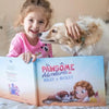 Girl lovingly holding her pet dog and being happy because she received a personalized book for pets as a gift.