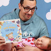 Father and daughter are bonding over reading a personalized book about the nighttime routine, which is also a fun farm book.