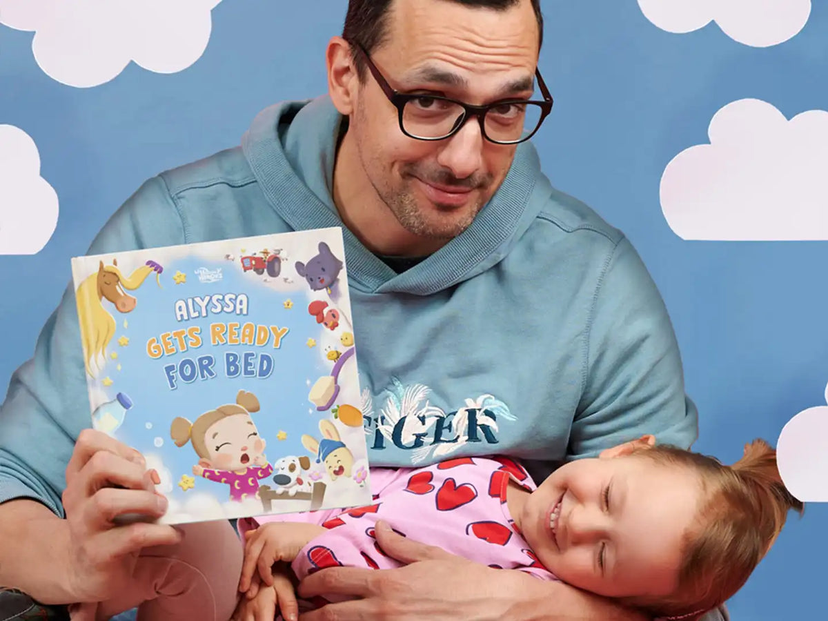 Father and daughter are bonding over reading a personalized book about the nighttime routine, which is also a fun farm book.