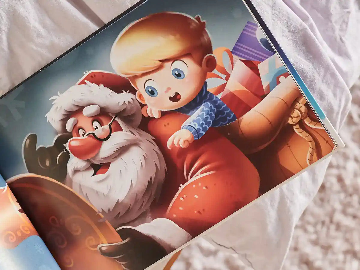 An illustration from the Hooray Heroes Christmas book features a personalized character of a little boy showing something to Santa Claus.