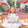 Girl is celebrating her birthday with Hooray Heroes' personalized book for birthday.