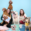 Pet owners and their dogs holding personalized dog books from Hooray Heroes, celebrating beloved pets with titles like 'Bella Was the Goodest Girl' and 'Libby the Goodest Girl'—a heartfelt memorial gift for dogs who’ve passed.