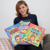 A boy is holding three different covers of personalized book of fun facts which are more fun than book of records.
