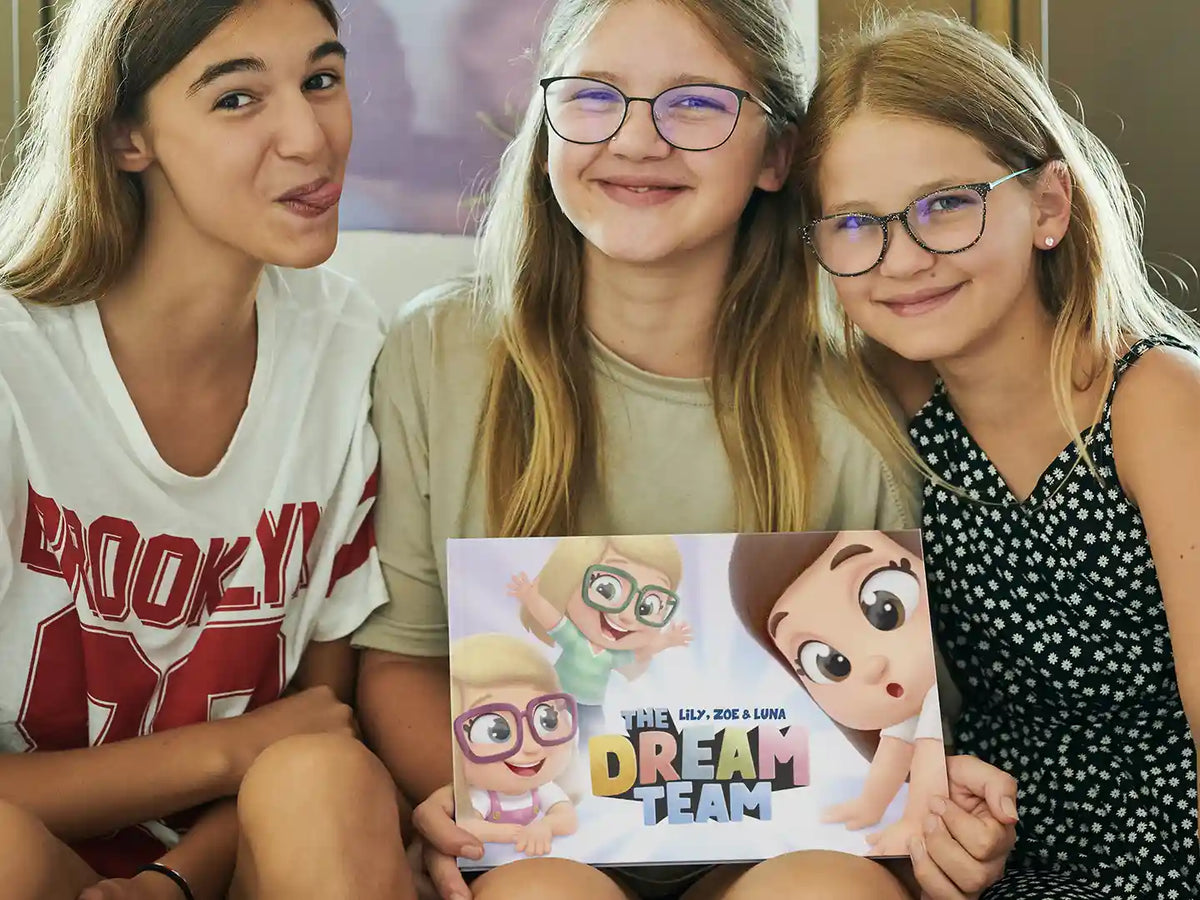 3 little girls holding their personalized story book for children, a lovely gift for Birthday or Christmas.