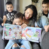 Mom and her three kids are looking at the illustration inside the custom family book which is a great gift for three kids.