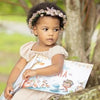 Three year old girl is holding her custom birthday book she got for her third birthday.