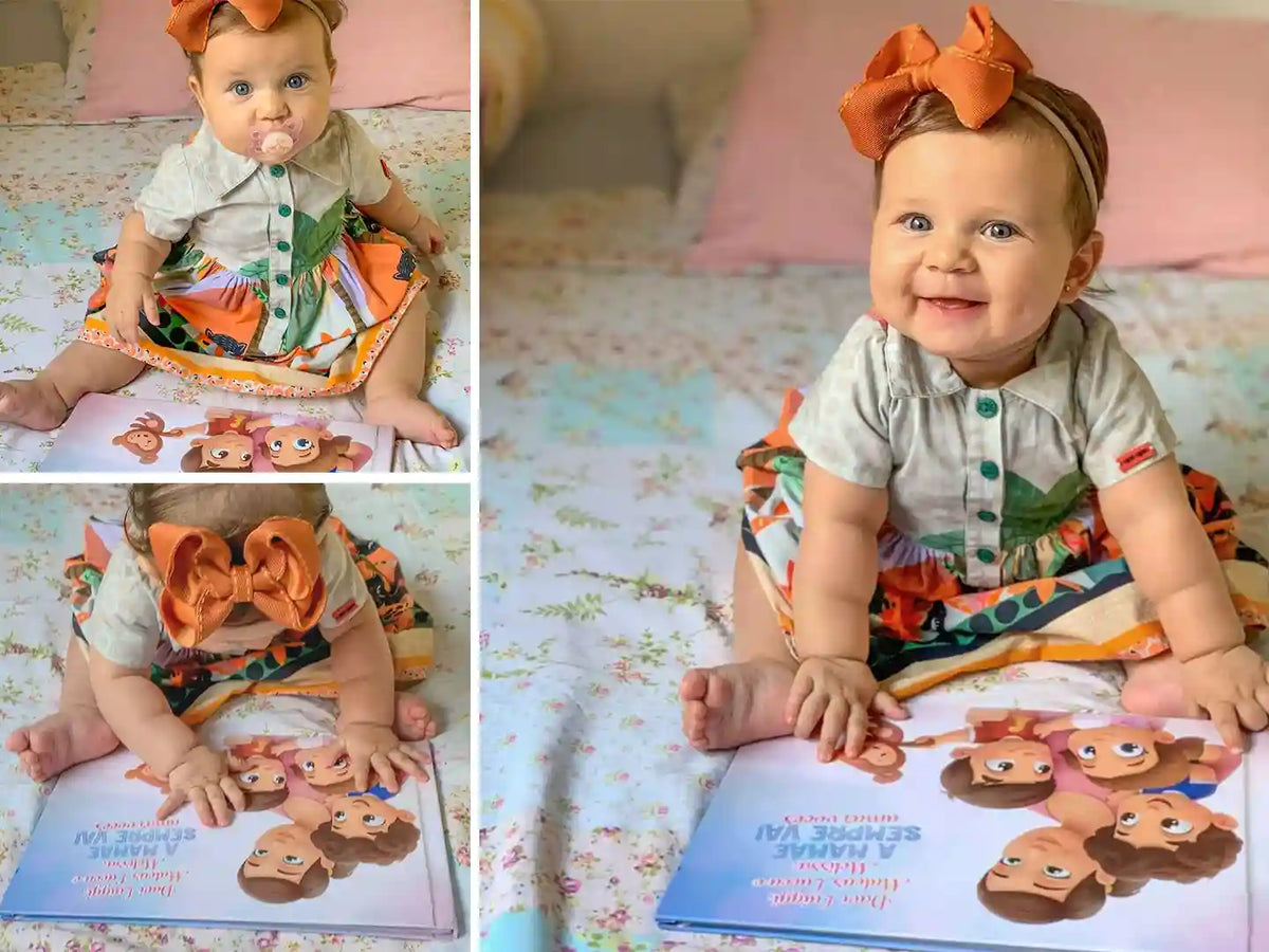 Little girl in floral dress pointing to the cover of a personalized storybook for mom and her kids.
