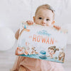 Girl holding the best gift for birthday which is a DIY storybook for a child's birthday.