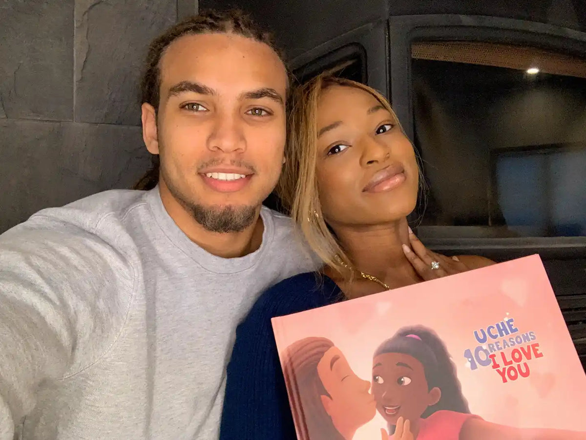 Lovely couple holding their romantic personalized book from Hooray Heroes.