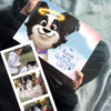 Custom illustrated dog memorial book "Roxie Was the Goodest Girl" by Hooray Heroes shown alongside personal photos of a girl and her dog.