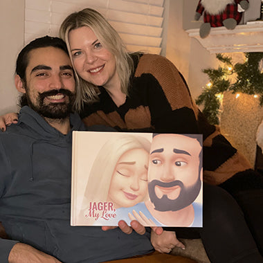 A couple embraces on a chair with their personalized love book, the best present for boyfriends or husbands.
