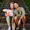 Two men with the best gift for Valentine's day: a personalized love book from Hooray Heroes, in premium edition.