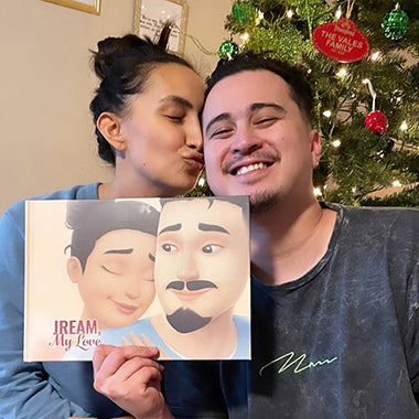 A woman kisses her boyfriend after giving him a super personalized love book for Christmas, best gift for him.