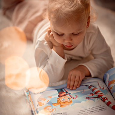 A little girl reads her custom Christmas book for one child, the best gift for Xmas.