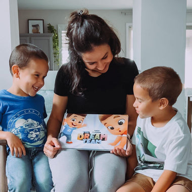 Mommy and her two sons look at their new DIY adventure book for cousins, friends and siblings..