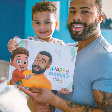 Dad and child with a custom Mother's Day book for mom. 