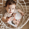 A boy with a Mother's Day present for mom a custom mommy book about the fun they have and the bond they share.
