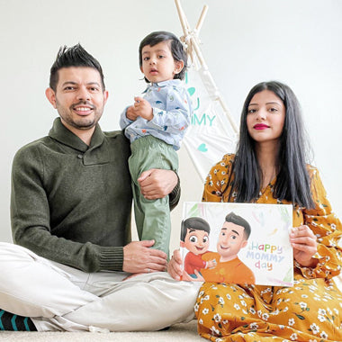 Mom, dad and child giving mommy a special DIY book for Mother's Day from dad and son.