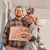 A man and woman smile with the best gift for boyfriends, a unique DIY couples' love book for him.