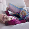 A six-year-old girl is reading her personalized birthday book.
