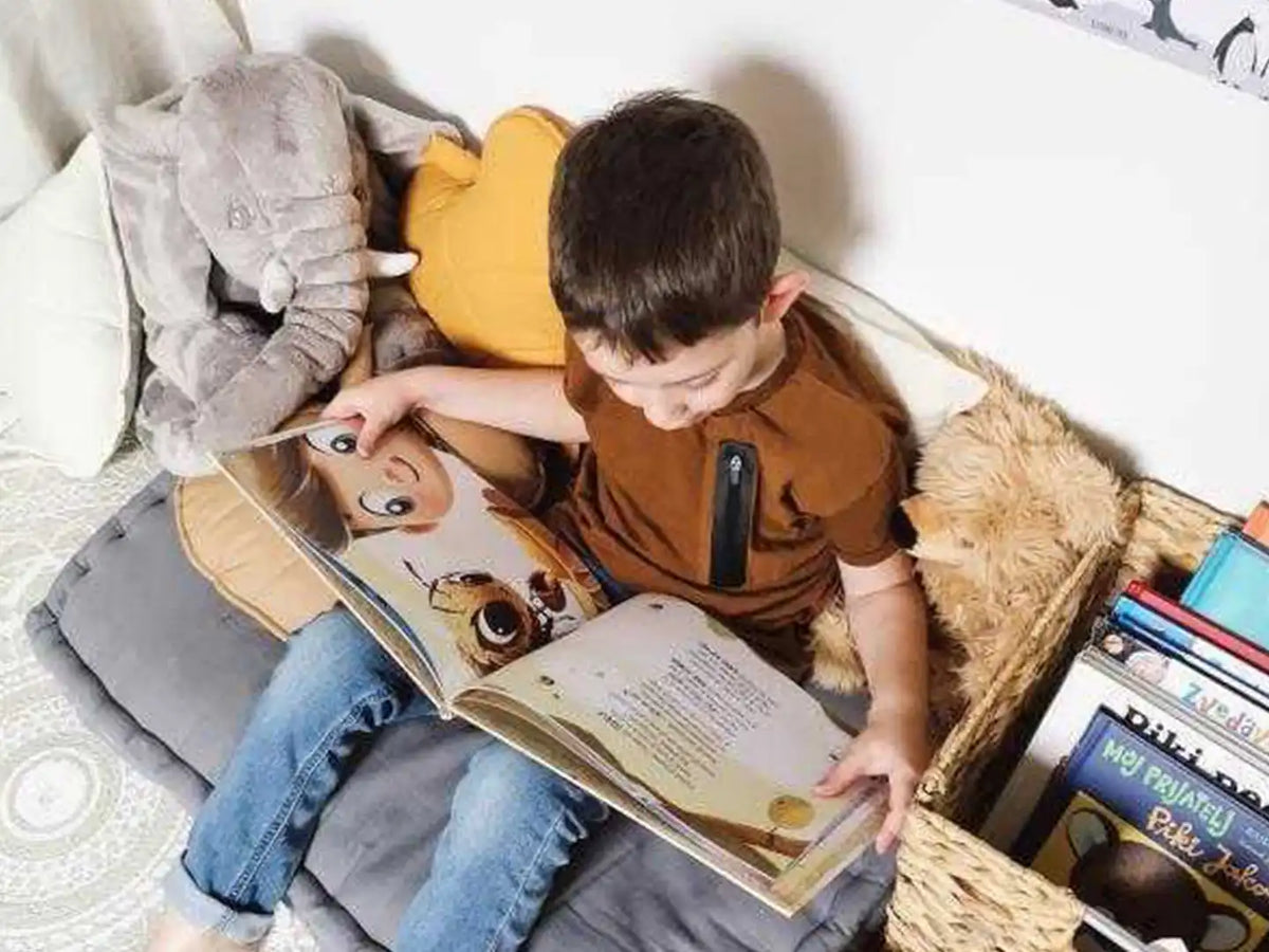 A seven-year-old boy is reading his personalized birthday book.