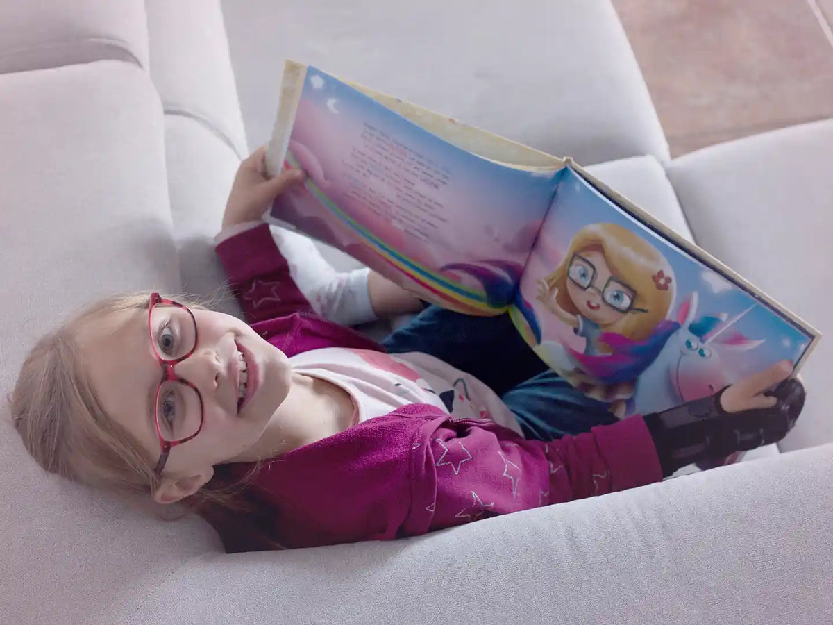 A nine-year-old girl is reading her personalized birthday book.