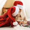 Two girls enjoying their personalized Christmas book.