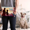 Personalized hardcover book 'Daniel the Best Dog Dad' held by owner, with his dog in the background — the perfect Father's Day surprise for dog dads.