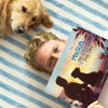 Man holding a personalized 'Best Dog Dad' book next to a golden retriever — best Father's Day gift idea for a dog lover.