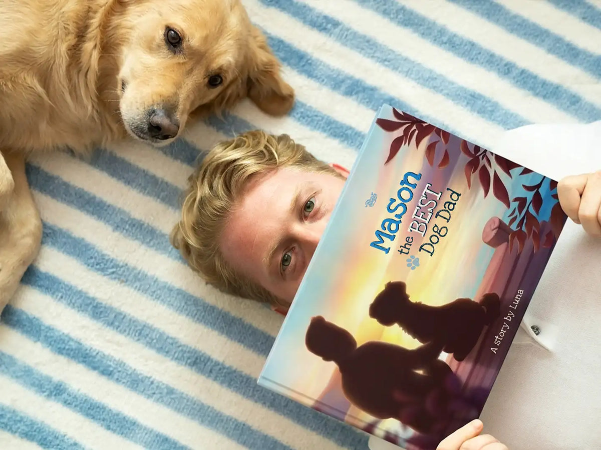 Man holding a personalized 'Best Dog Dad' book next to a golden retriever — best Father's Day gift idea for a dog lover.