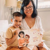 A smiling boy and his grandma with their new personalized book with them as the main characters.
