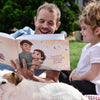 A smiling girl and her grandpa reading their new personalized book with them as the main characters.