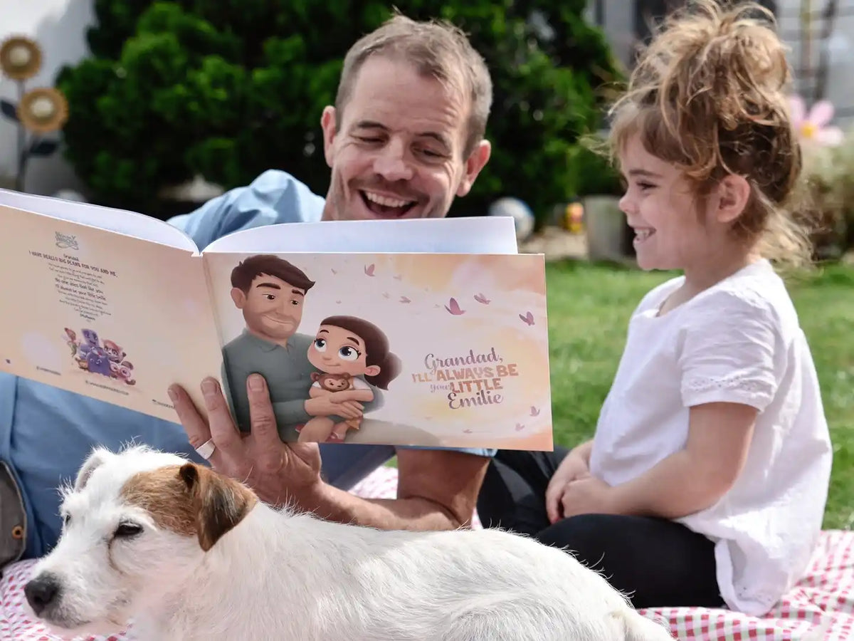A smiling girl and her grandpa reading their new personalized book with them as the main characters.