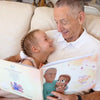 A grandpa and his granddaughter with their personalized book from Hooray Heroes.