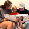 Boy and parents reading a personalized book for dad.