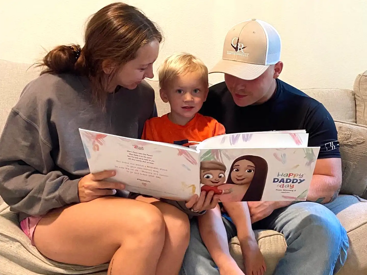 Boy and parents reading a personalized book for dad.