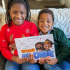 Two siblings holding their new personalized Home Alone book.