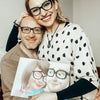 A smiling couple holding their personalized book for couples.
