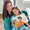 Mom and daughter with a custom Mother's Day book for her from Daddy and child.