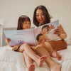 Mother and child bonding over the perfect Mother's Day gift, a custom book for mother and child.
