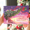 Personalized Christmas book “Mila and Daddy’s First Christmas 2025” shown near decorated Christmas tree.